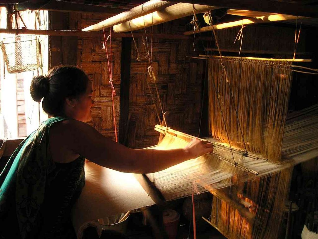 Nepalese artisans working on traditional woolen crafts.